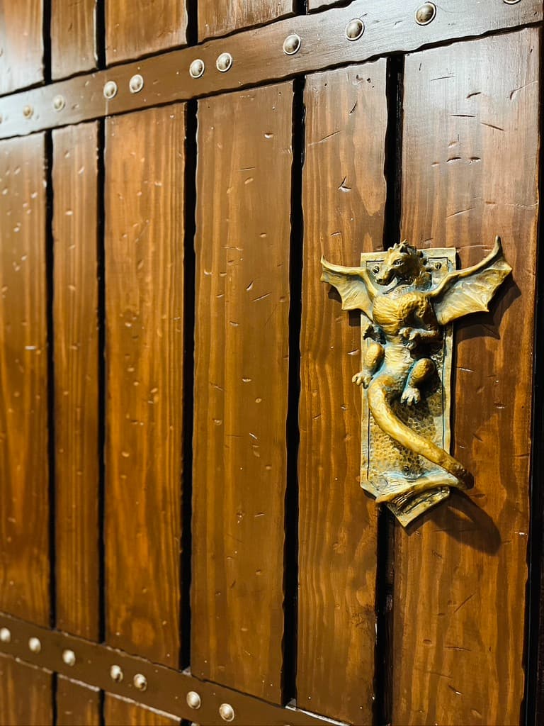 HARRY POTTER'S gothic Commons Room has custom castle doors, ceiling beams, and block walls!
