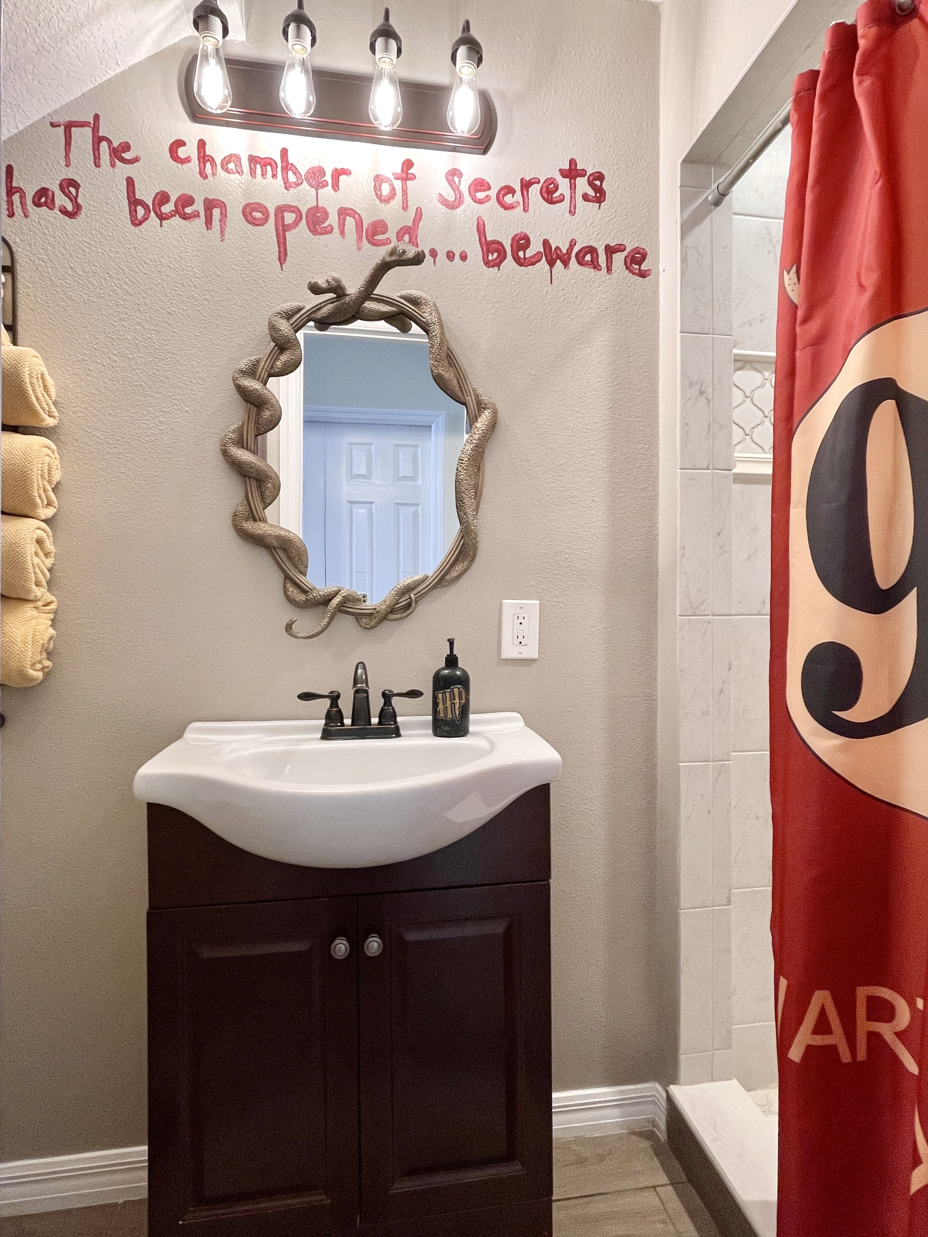 HARRY POTTER's small bathroom is just a couple steps into the hall from each of his themed bedrooms.  Standing shower.