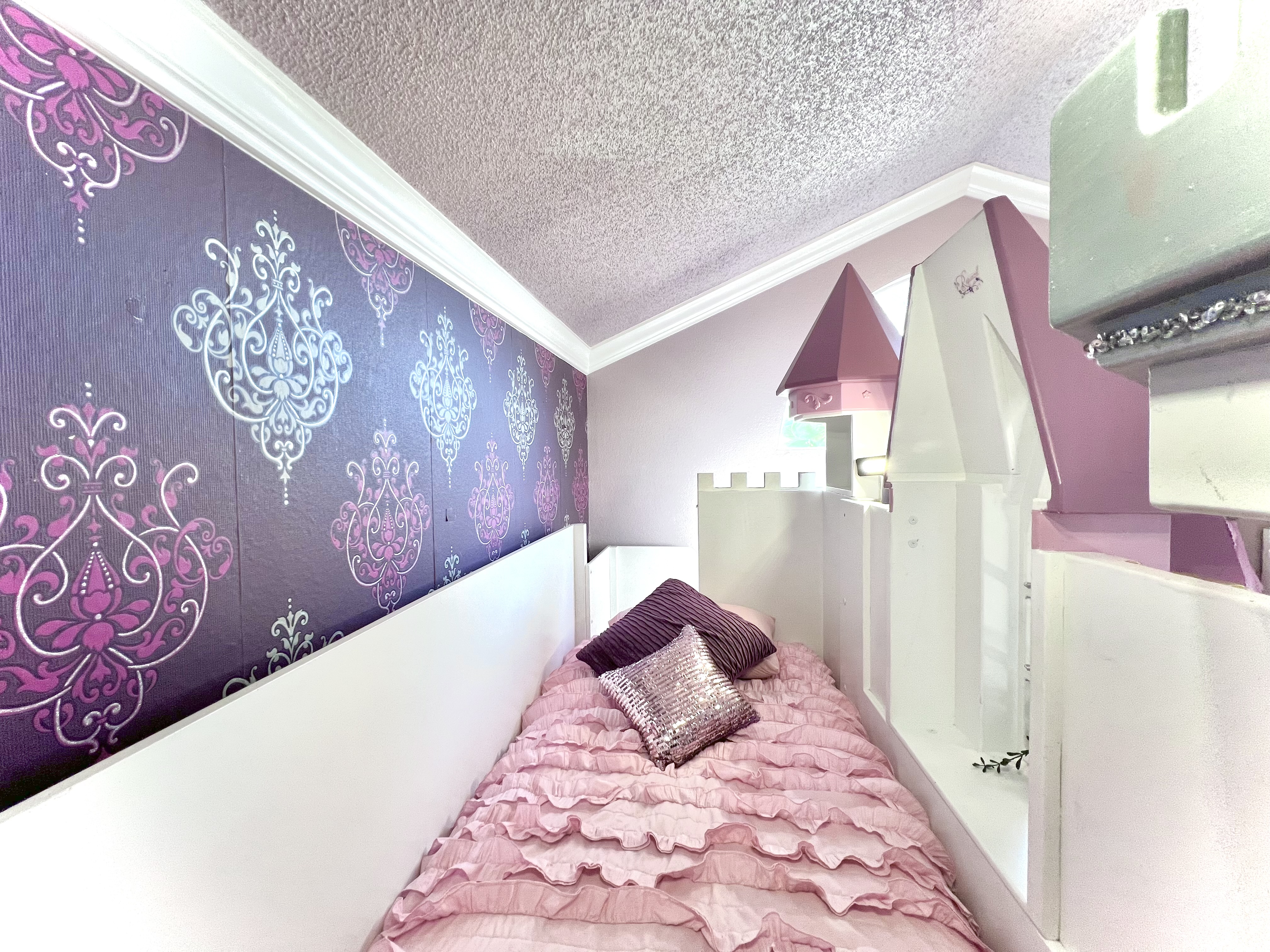 Rapunzel's beautiful tower and castle bunk bedroom sleeps 2, with has two twin beds (top is shown here), and a slide. Main level.