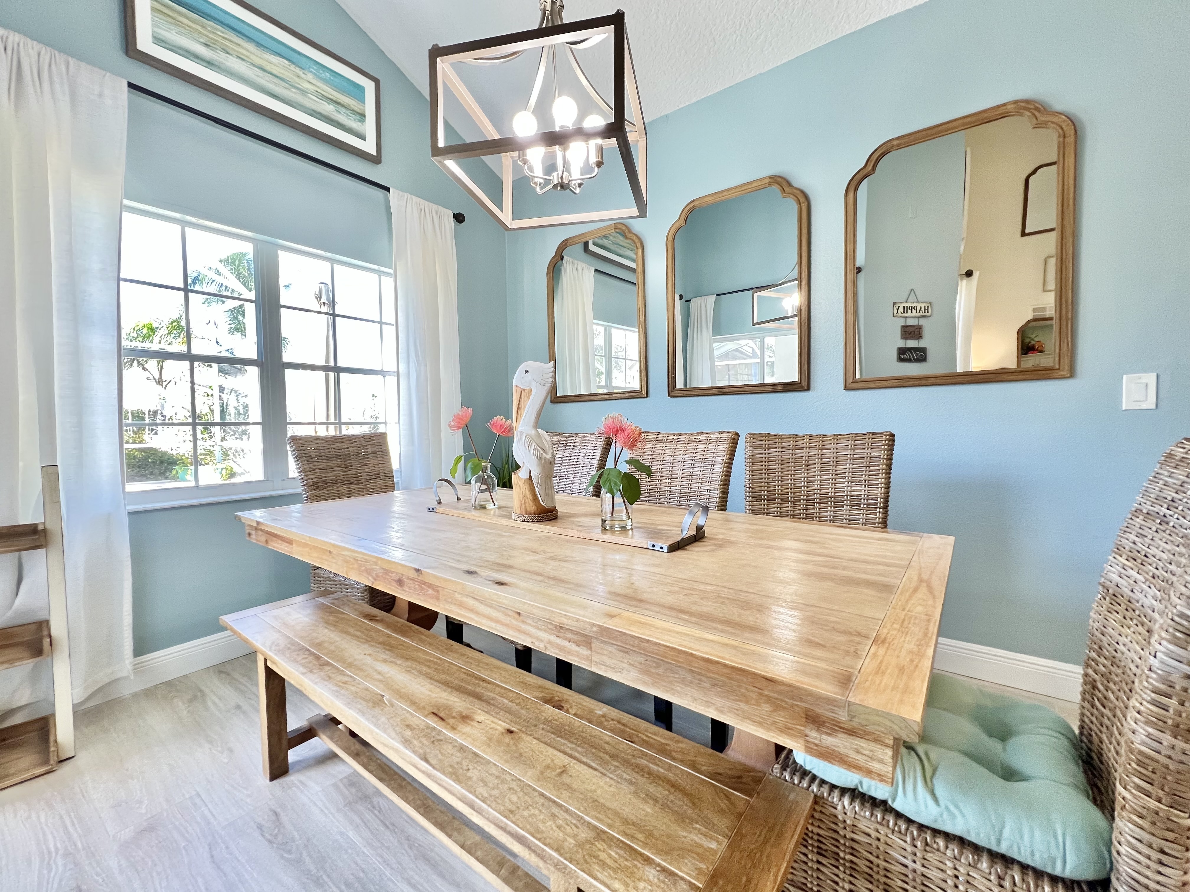 Gorgeous pool view from the dining table, with both a patio slider and large window facing the backyard oasis!